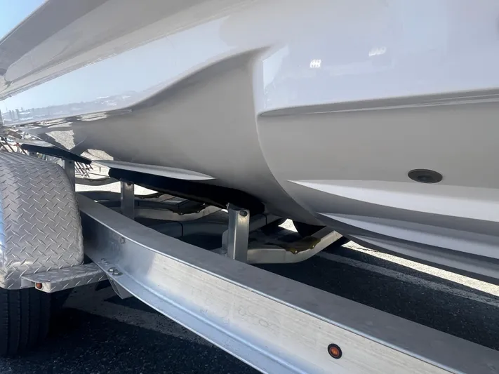  Yacht Photos Pics 2022 Axopar 28 CABIN boat on trailer, showcasing sleek hull design.