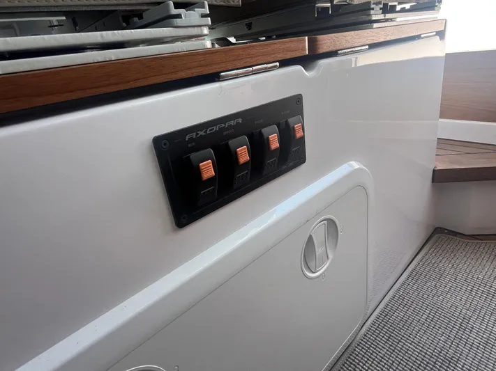  Yacht Photos Pics 2022 Axopar 28 CABIN interior with control panel and wooden accents.