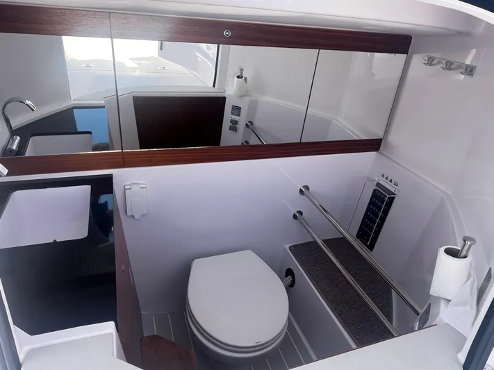  Yacht Photos Pics 2022 Axopar 28 CABIN bathroom with modern fixtures and sleek design.