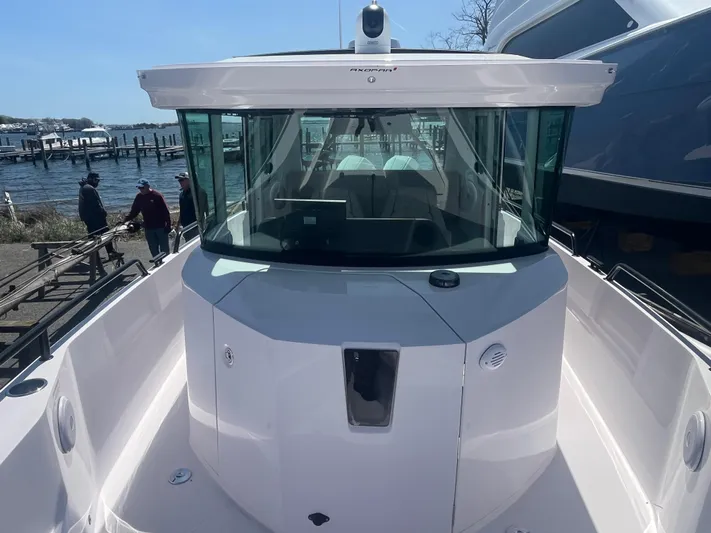  Yacht Photos Pics 2022 Axopar 28 CABIN boat docked, showcasing sleek design and spacious cabin.