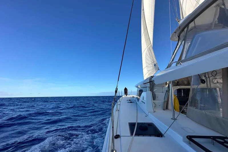  Yacht Photos Pics Sailing on a 2022 Lagoon 46 catamaran in open ocean under clear blue skies.