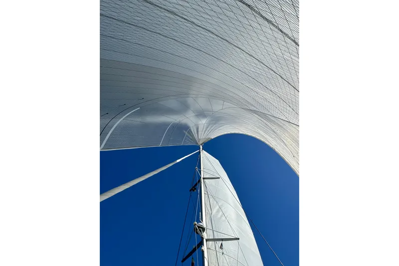  Yacht Photos Pics Sails of a 2022 Lagoon 46 catamaran against a clear blue sky.