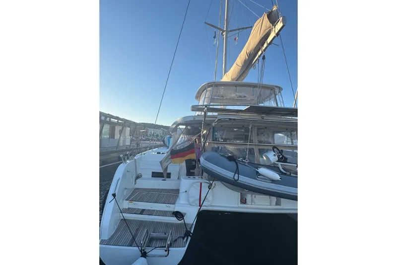  Yacht Photos Pics 2022 Lagoon 46 catamaran docked, featuring a sleek design and modern amenities.