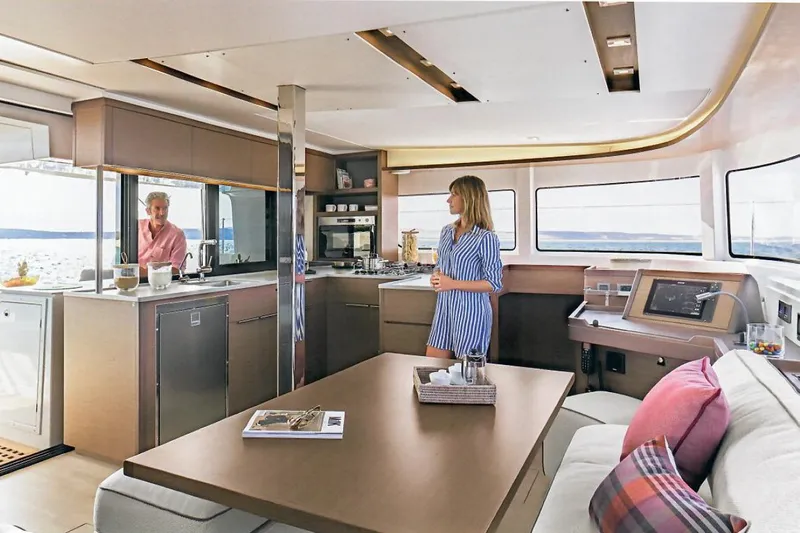  Yacht Photos Pics Interior of 2022 Lagoon 46 catamaran with modern kitchen and seating area.