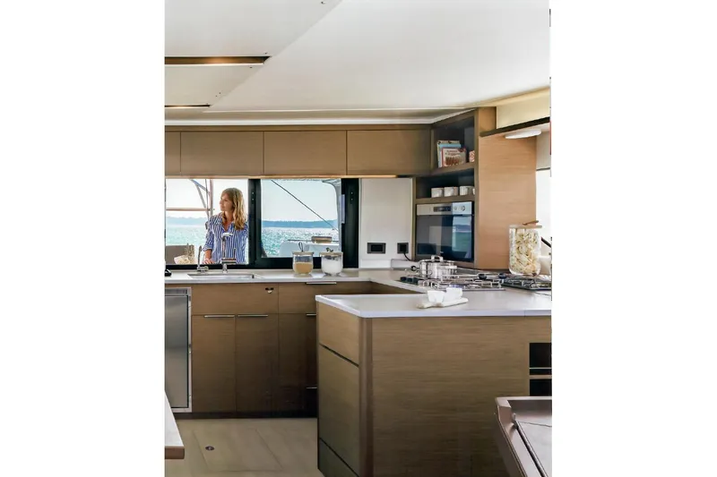  Yacht Photos Pics Modern kitchen interior of 2022 Lagoon 46 yacht with ocean view.