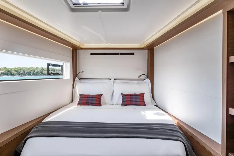  Yacht Photos Pics Luxurious bedroom interior of 2022 Lagoon 46 yacht with scenic window view.