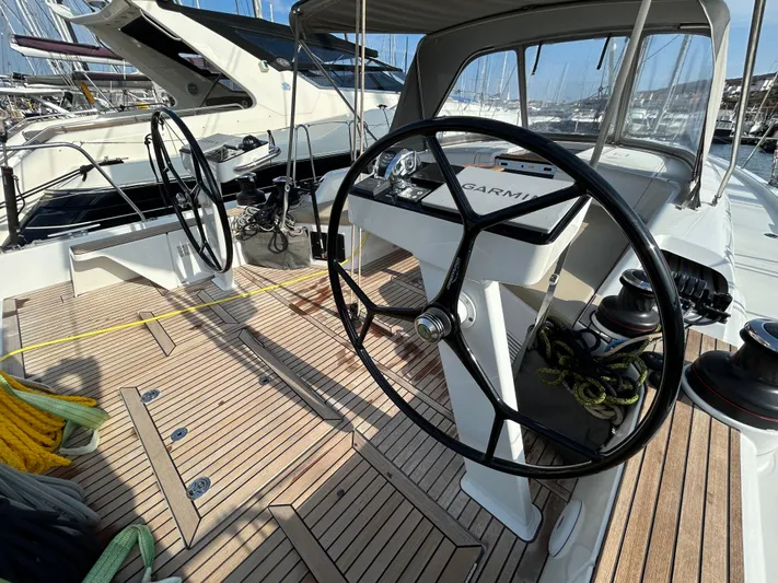  Yacht Photos Pics 2023 Beneteau First 44 yacht cockpit with dual steering wheels and teak decking.