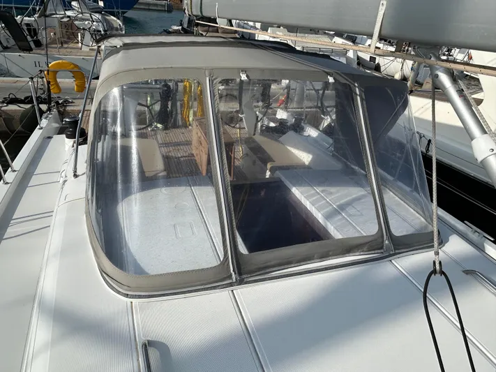  Yacht Photos Pics 2023 Beneteau First 44 sailboat cockpit with protective canopy and clear windows.