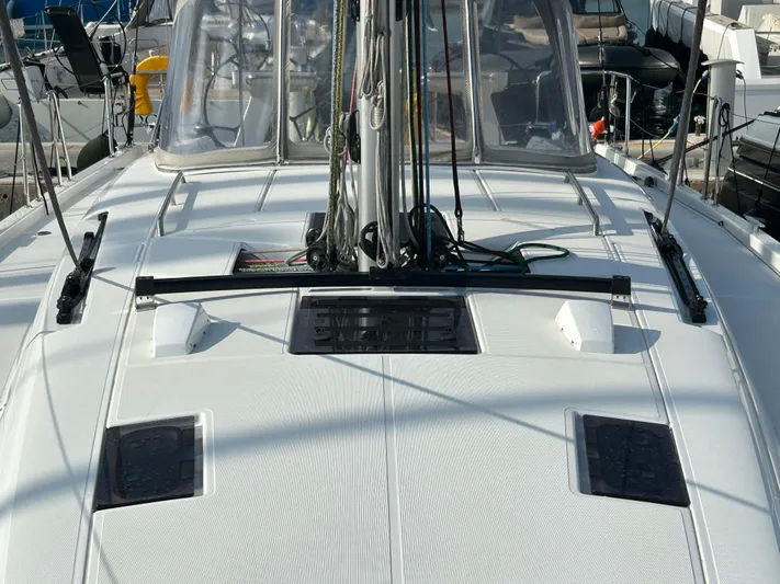  Yacht Photos Pics 2023 Beneteau First 44 sailboat deck with rigging and hatches in marina setting.
