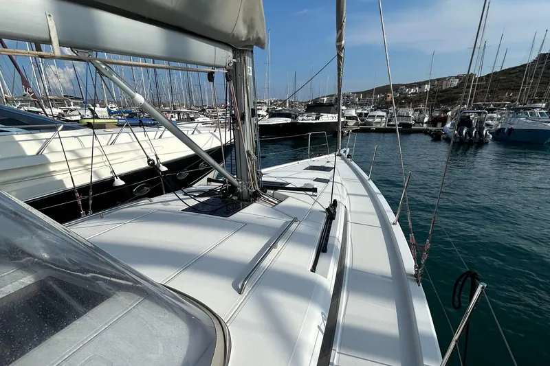  Yacht Photos Pics 2023 Beneteau First 44 sailboat docked in a marina, showcasing sleek deck design.