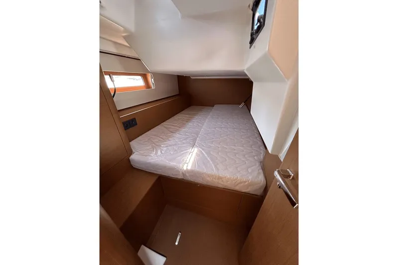  Yacht Photos Pics 2024 Beneteau First 44 cabin interior with bed and wooden finish.