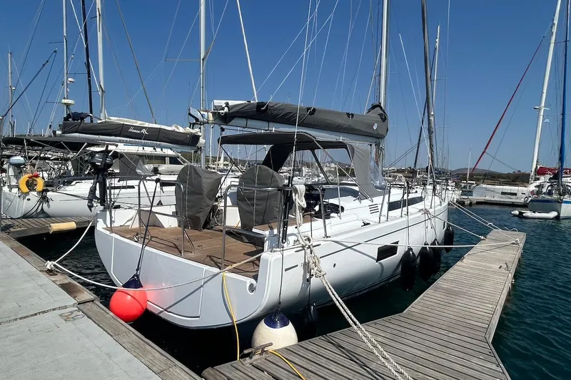  Yacht Photos Pics 2024 Beneteau First 44 sailboat docked at marina, clear blue sky.