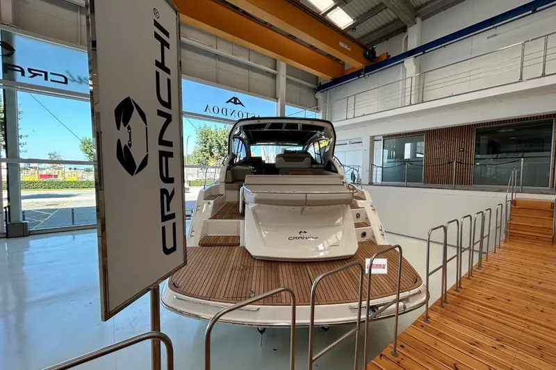  Yacht Photos Pics 2025 Cranchi M44HT yacht displayed in a modern indoor showroom.