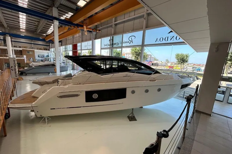  Yacht Photos Pics 2025 Cranchi M44HT luxury yacht displayed in a showroom.