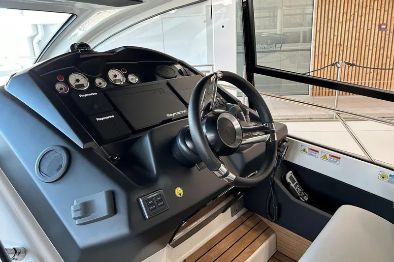  Yacht Photos Pics 2025 Cranchi M44HT yacht helm with modern controls and sleek steering wheel.