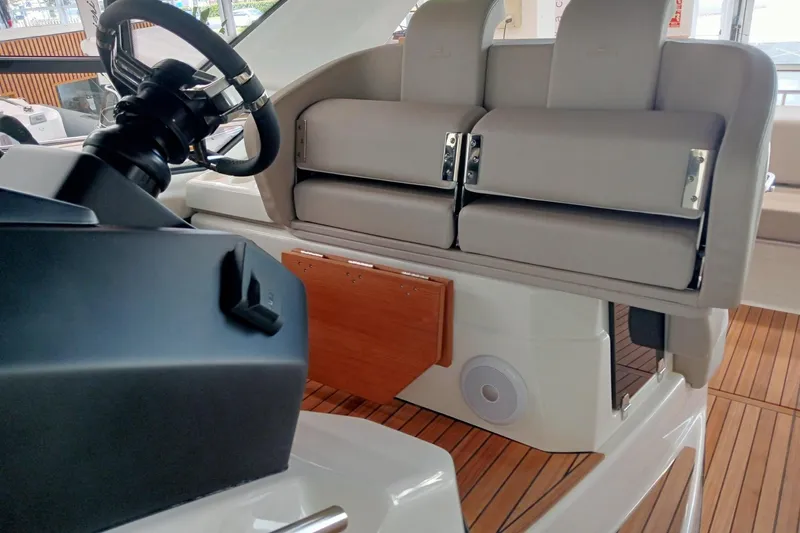  Yacht Photos Pics 2025 Cranchi M44HT yacht helm with modern steering and cushioned seating.