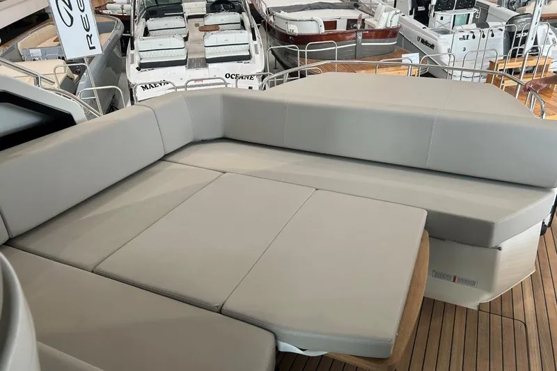  Yacht Photos Pics Luxurious seating area on 2025 Cranchi M44HT yacht, featuring sleek design and comfortable cushions.
