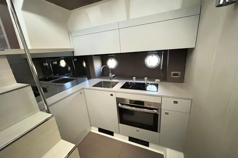  Yacht Photos Pics Modern kitchen interior of 2025 Cranchi M44HT yacht, featuring sleek cabinetry and appliances.