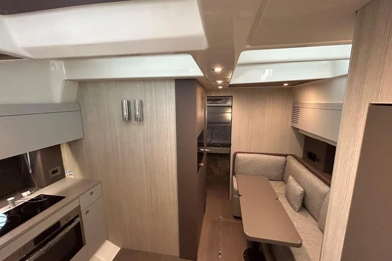  Yacht Photos Pics Luxurious interior of 2025 Cranchi M44HT yacht with modern kitchen and cozy seating area.