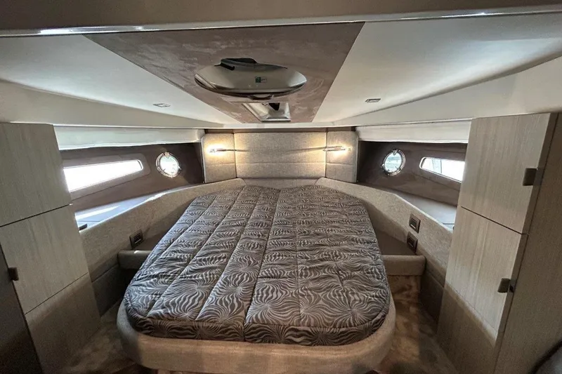  Yacht Photos Pics Luxurious cabin interior of 2025 Cranchi M44HT yacht with elegant bedding and modern design.