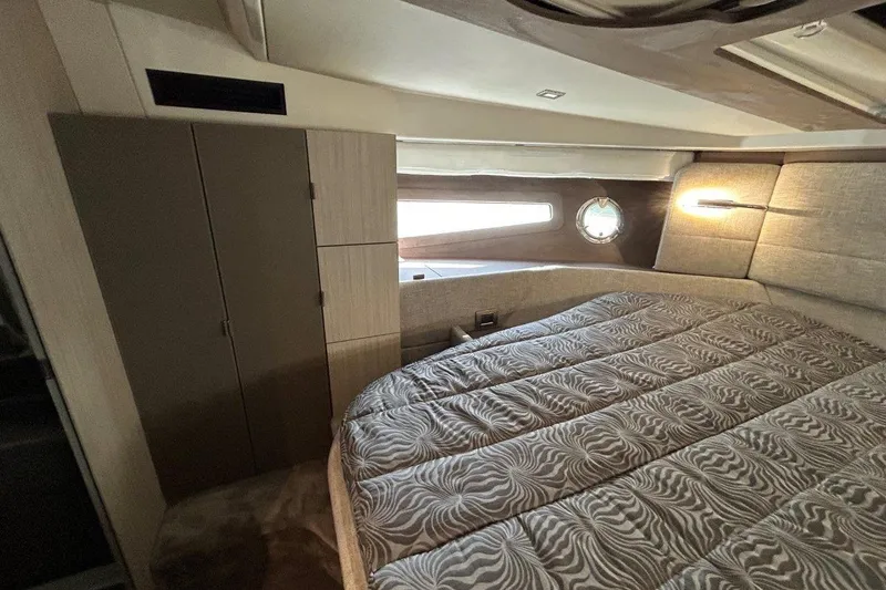  Yacht Photos Pics Luxurious interior cabin of 2025 Cranchi M44HT yacht with elegant bedding and modern design.