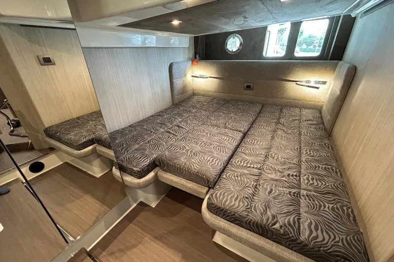  Yacht Photos Pics Luxurious cabin interior of 2025 Cranchi M44HT yacht with patterned bedding.