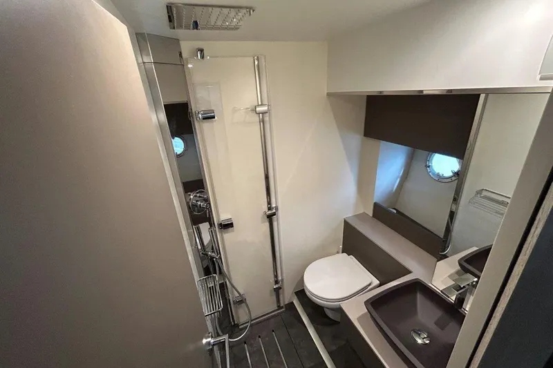  Yacht Photos Pics Modern bathroom in 2025 Cranchi M44HT yacht with shower, toilet, and sink.