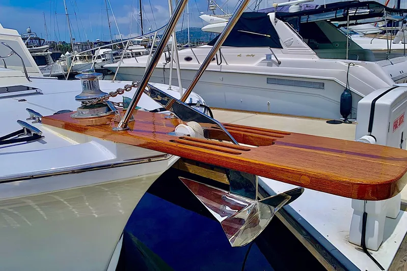 Dolce Vita Yacht Photos Pics 1984 Egg Harbor 48' Flybridge yacht with polished anchor and wooden bow detail.