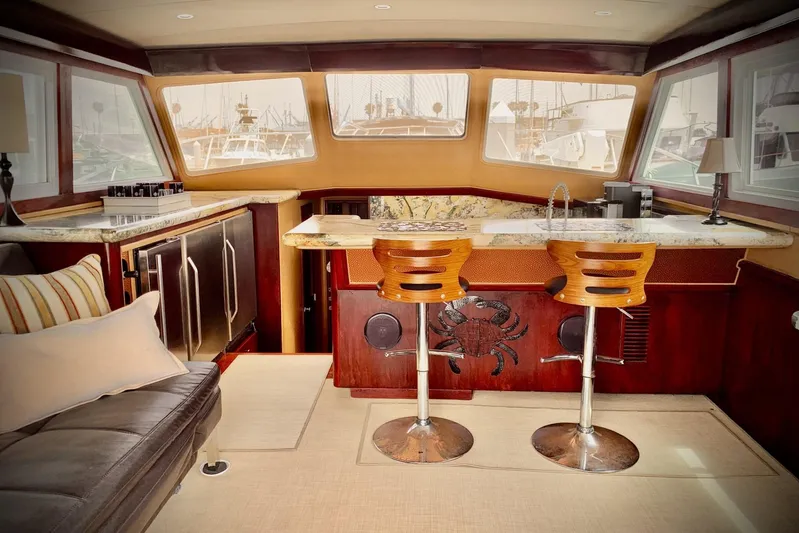 Dolce Vita Yacht Photos Pics Luxurious interior of 1984 Egg Harbor 48' Flybridge yacht with bar and seating area.