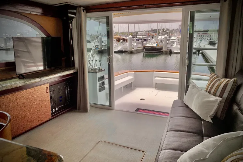 Dolce Vita Yacht Photos Pics Interior of 1984 Egg Harbor 48' Flybridge yacht with marina view through sliding doors.