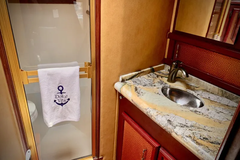 Dolce Vita Yacht Photos Pics Luxurious bathroom in 1984 Egg Harbor 48' Flybridge yacht with marble countertop and elegant fixtures.