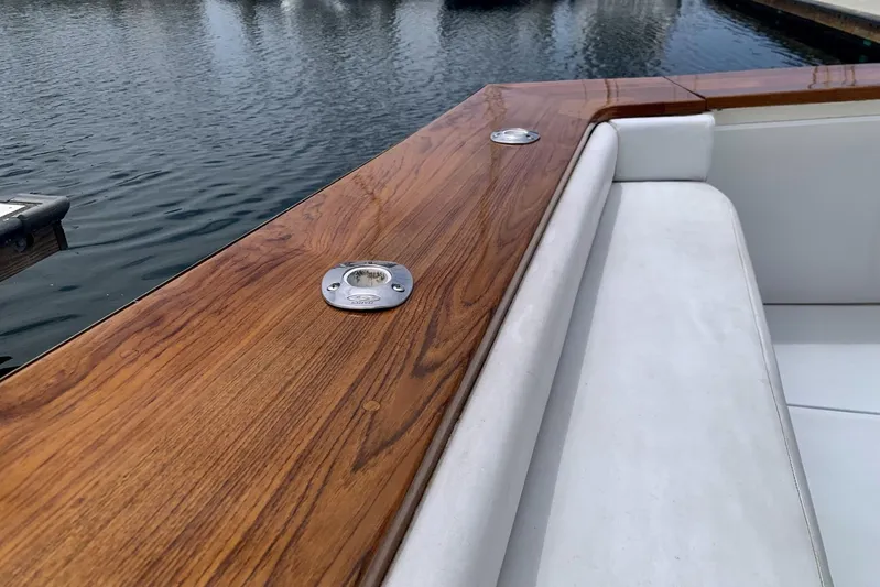 Dolce Vita Yacht Photos Pics 1984 Egg Harbor 48' Flybridge with polished wood and white seating by the water.