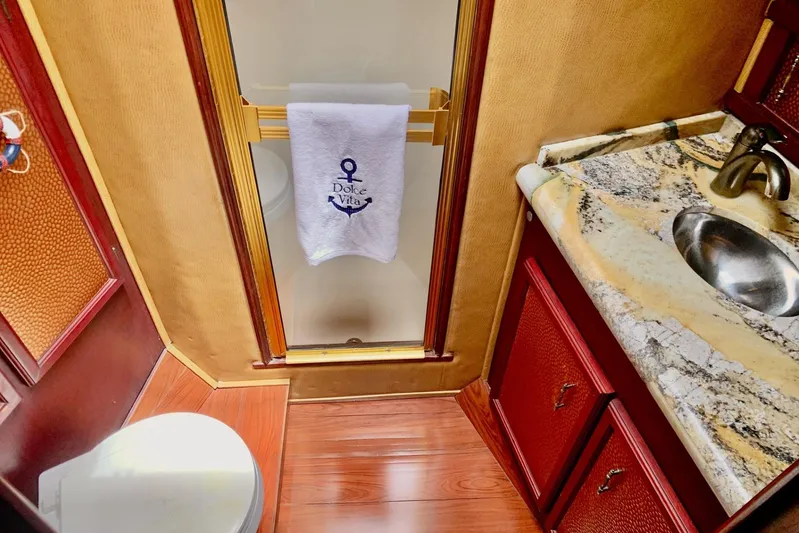 Dolce Vita Yacht Photos Pics Luxurious bathroom in 1984 Egg Harbor 48' Flybridge yacht with marble countertop and elegant fixtures.