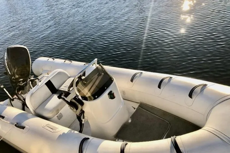 Dolce Vita Yacht Photos Pics Inflatable boat on water, sunny day reflections, Egg Harbor 48' Flybridge, 1984 model.