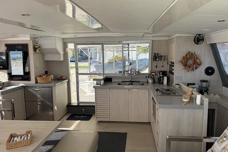  Yacht Photos Pics Modern kitchen interior on a 2017 Leopard 48 yacht, featuring sleek cabinetry and appliances.