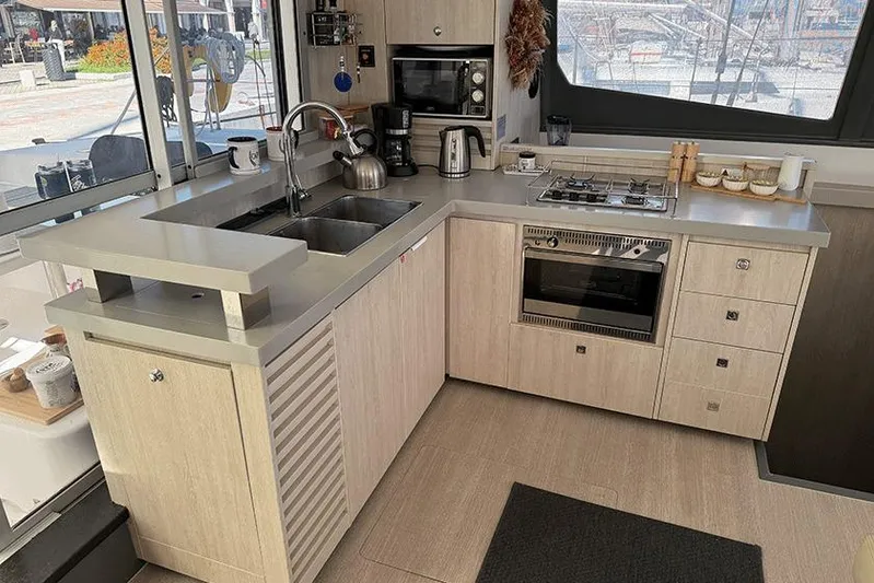  Yacht Photos Pics Modern kitchen in a 2017 Leopard 48 yacht, featuring appliances and sleek cabinetry.