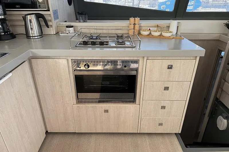  Yacht Photos Pics Modern kitchen in a 2017 Leopard 48 yacht with stove, oven, and sleek cabinetry.