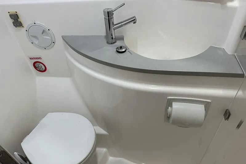  Yacht Photos Pics Compact bathroom in a 2017 Leopard 48 yacht, featuring a modern sink and toilet.