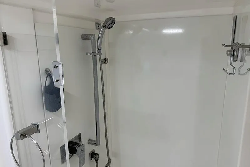  Yacht Photos Pics Modern shower area in a 2017 Leopard 48 yacht, featuring sleek fixtures and glass door.