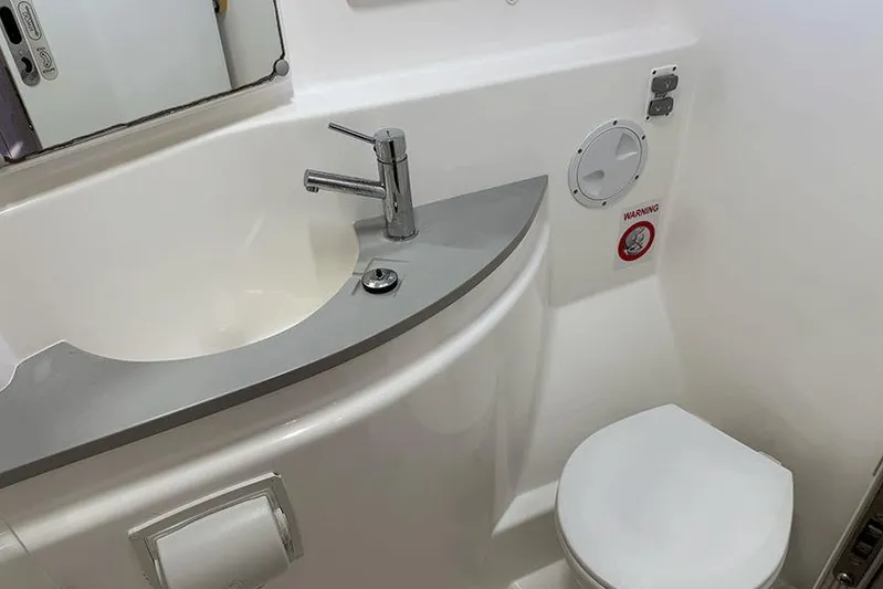  Yacht Photos Pics Modern bathroom in 2017 Leopard 48 yacht, featuring sleek sink and compact toilet design.