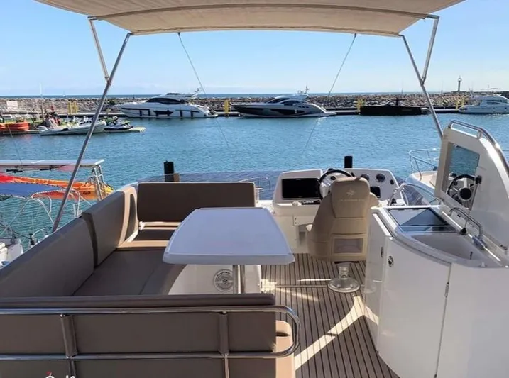 Tortuga Yacht Photos Pics 2017 Jeanneau Velasco 43F yacht with spacious deck and seating, docked at marina.