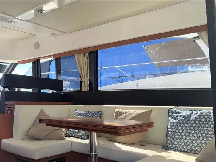 Tortuga Yacht Photos Pics Interior of 2017 Jeanneau Velasco 43F yacht with cushioned seating and table.