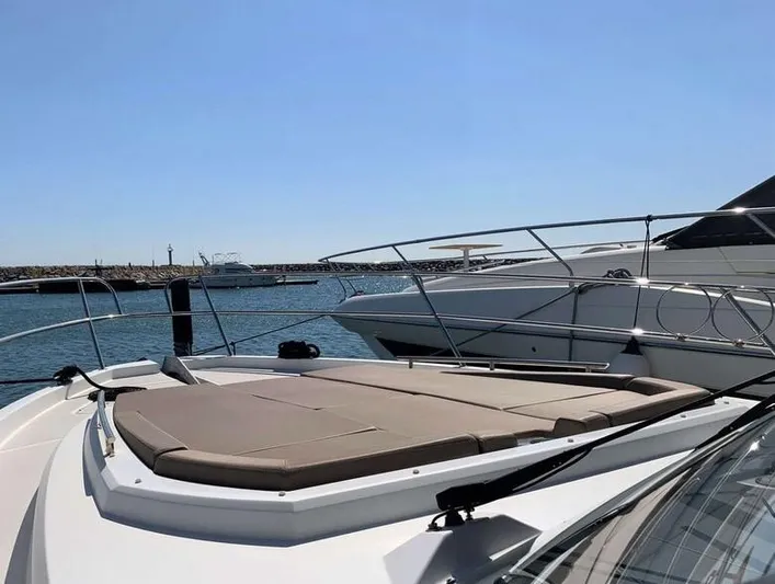 Tortuga Yacht Photos Pics 2017 Jeanneau Velasco 43F yacht with sun deck, docked in a marina under clear skies.