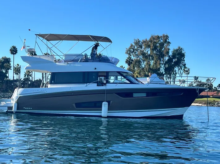 Tortuga Yacht Photos Pics 2017 Jeanneau Velasco 43F yacht on calm water, clear sky background.