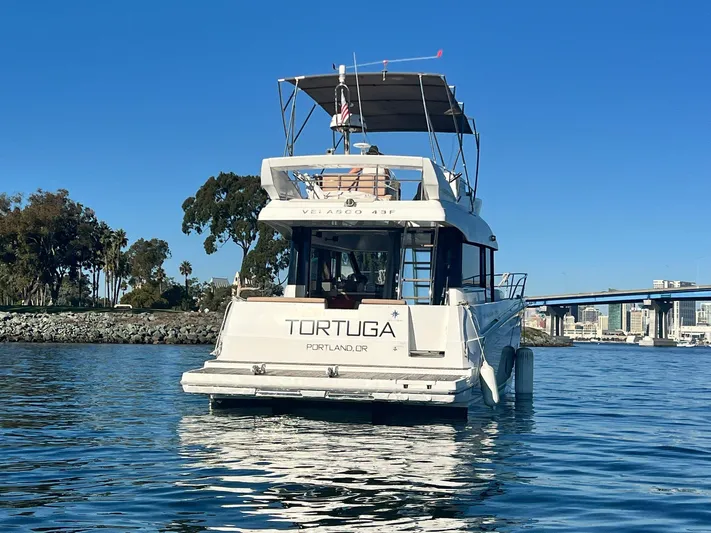 Tortuga Yacht Photos Pics 2017 Jeanneau Velasco 43F yacht on calm water, clear sky, and scenic background.