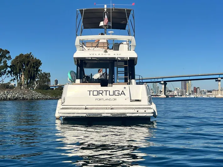 Tortuga Yacht Photos Pics 2017 Jeanneau Velasco 43F yacht "Tortuga" on water, cityscape and bridge in background.