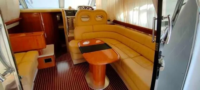  Yacht Photos Pics Luxurious interior of 2004 Cranchi Atlantique 40 yacht with elegant seating and wooden table.