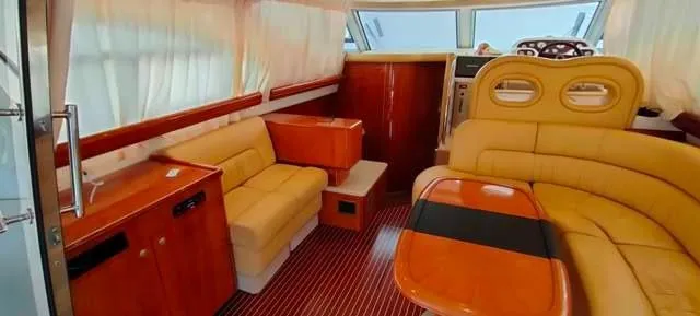  Yacht Photos Pics Luxurious interior of 2004 Cranchi Atlantique 40 yacht with elegant seating and wooden finishes.