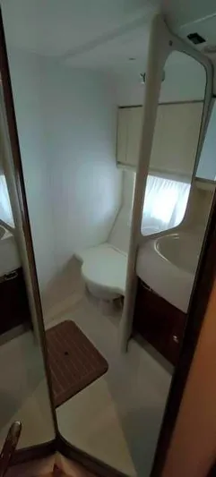  Yacht Photos Pics Bathroom interior of 2004 Cranchi Atlantique 40 yacht, featuring toilet and sink.