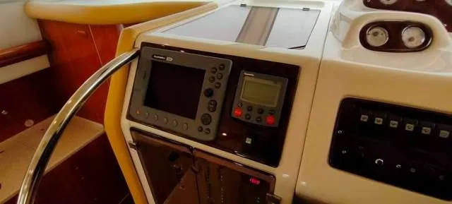  Yacht Photos Pics Control panel of 2004 Cranchi Atlantique 40 yacht with navigation instruments and steering wheel.